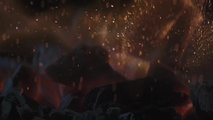 Embers are smoldering as a fire burns