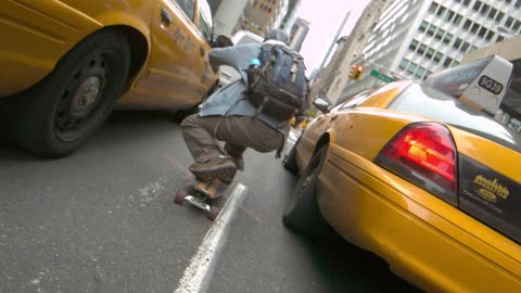 A skater passes between two cabs