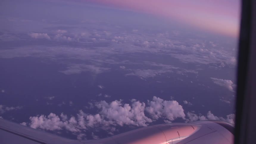 Clouds are seen from the window of an airplane