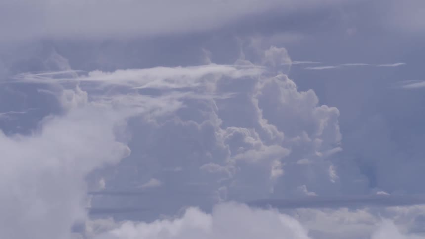 Clouds float in the blue sky