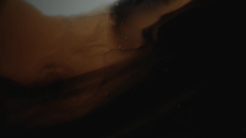 Varying shades of brown liquid are moved by something