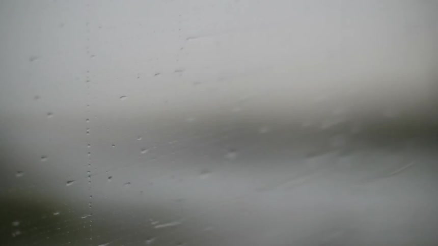 Rain crawls along the window