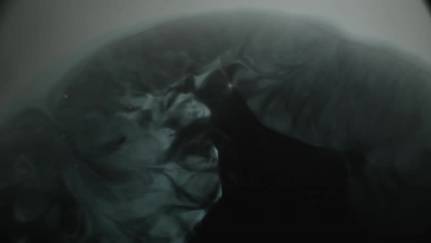 Ink swirls and mixes in churning water