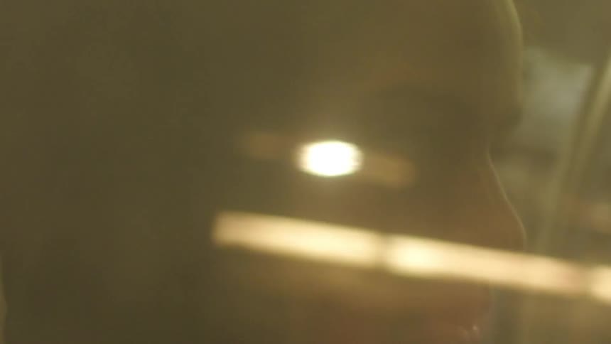 Woman in a black hood bobbing her head