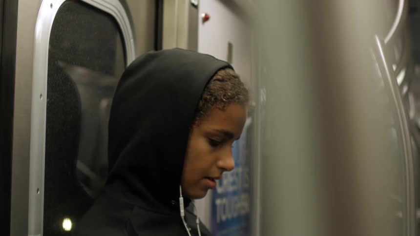 A woman sings to herself while riding public transportation
