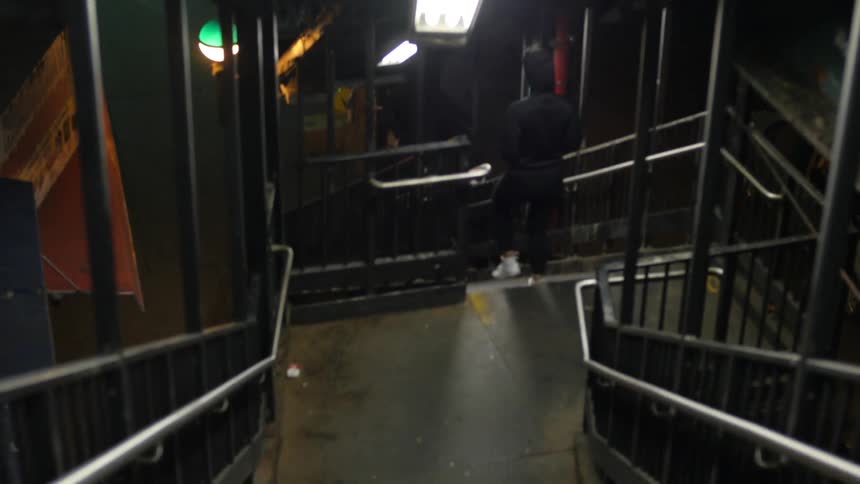 A person walks down two sets of stairs