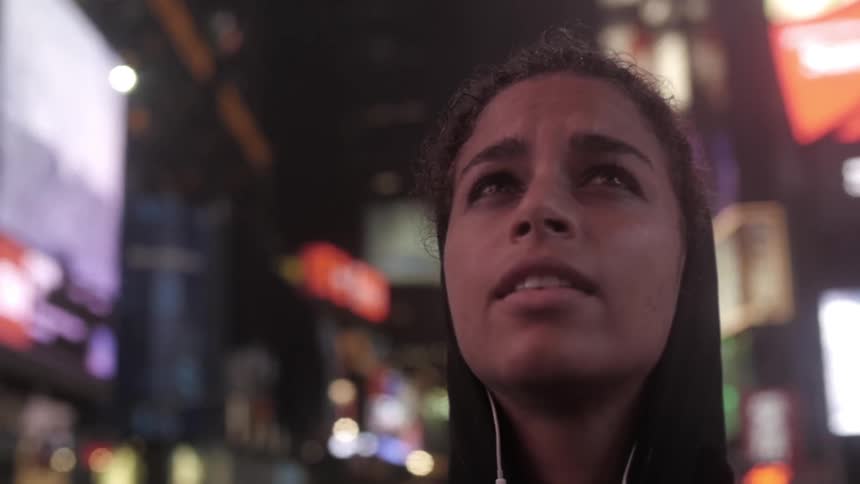 A young person marvels at the bright city lights