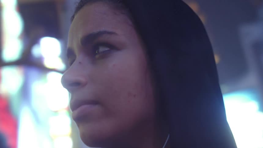 A woman looks up into the night sky