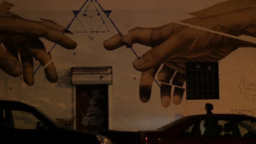 A large mural is painted on the side of a building