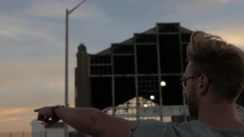 A man is pointing at something in the distance