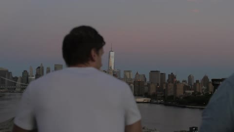 Three men look out over the city