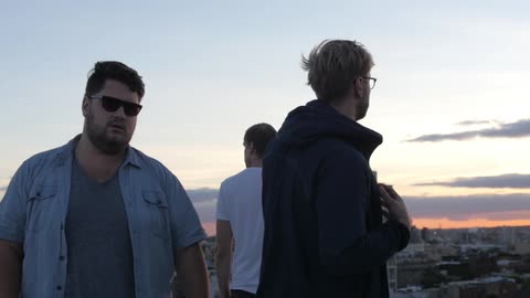 Men are thinking on top of a building