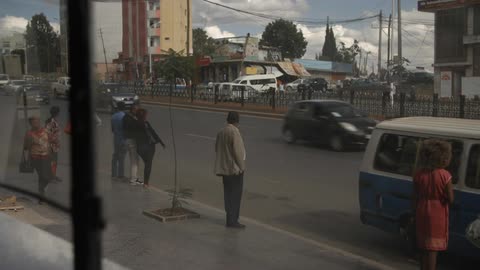 People walk along a busy street