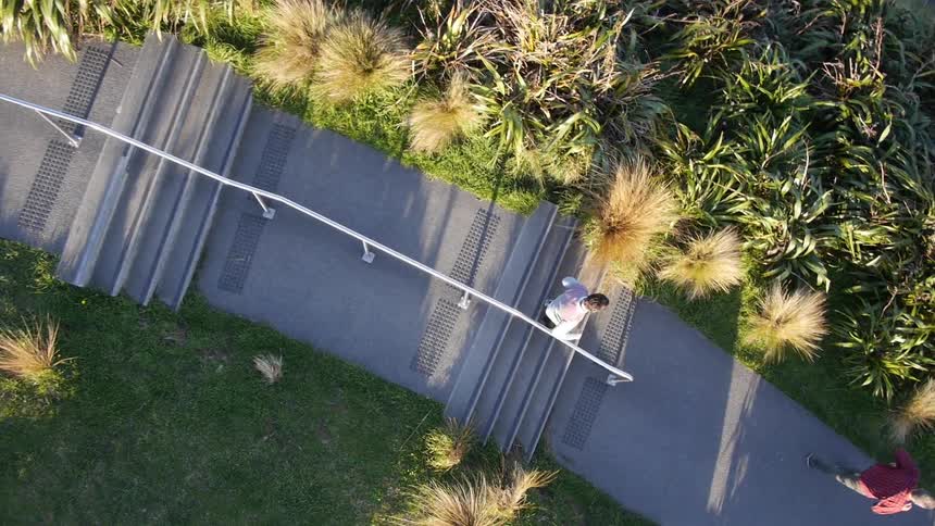 Two people walking down steps outside
