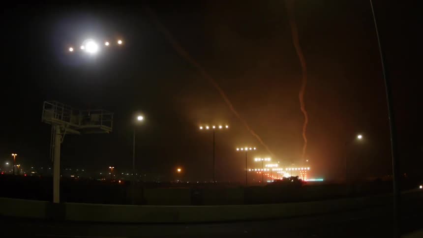 A plane lands at an airport at night