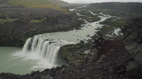 A waterfall cascades over a mountain