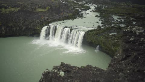A waterfall cascades over a mountain