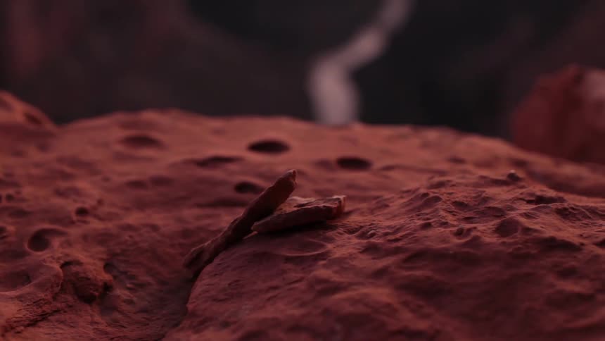 Red clay in focus with a river in the background