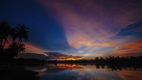 The sun sets over a lake