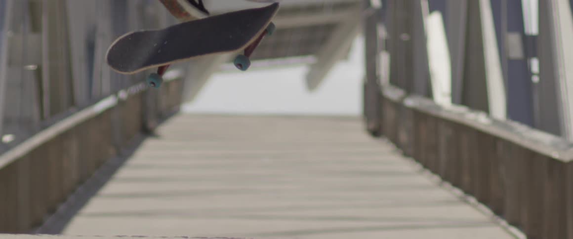 A man is doing tricks on his skateboard