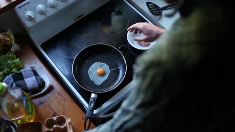 A woman is preparing to cook
