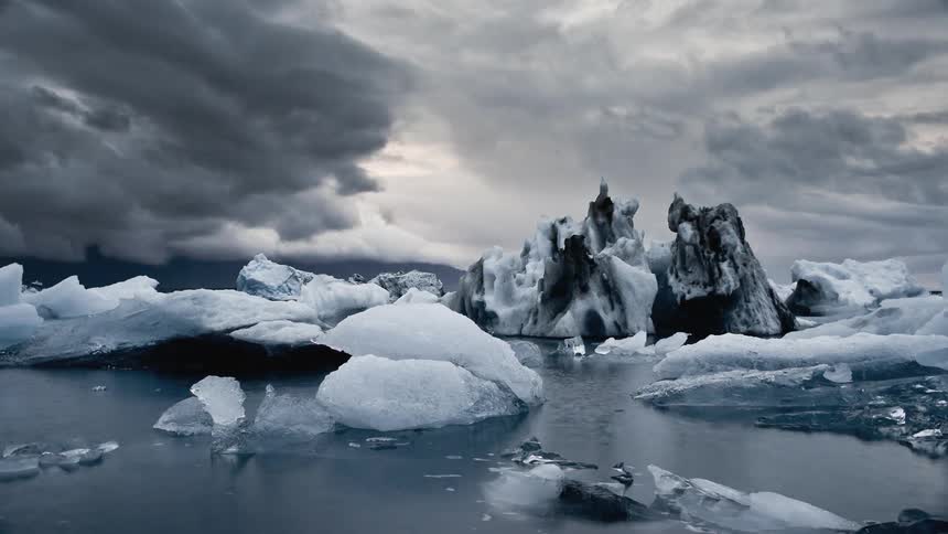 Timelapse of storm clouds building over an arctic lake filled with floating chunks of ice