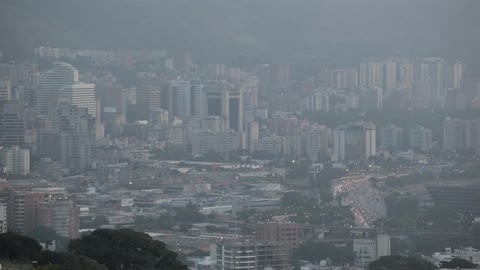 A city is bustling at night and into the morning