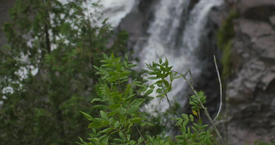The waterfall pours over the cliff