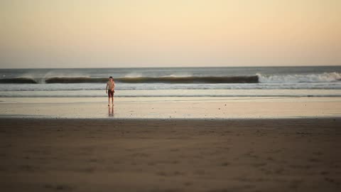 boy throwing rocks on the beach