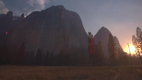 A mountain looms over a field