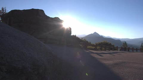 The sun comes up over a mountain