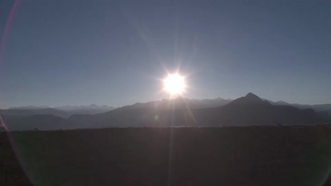 A view if the sun setting behind the mountains