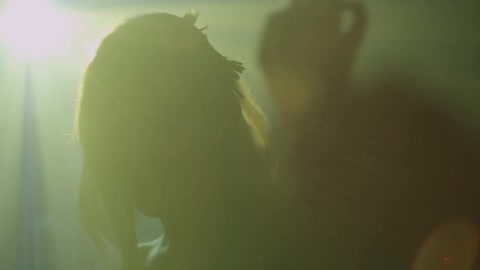 A person standing in front of strobe lights