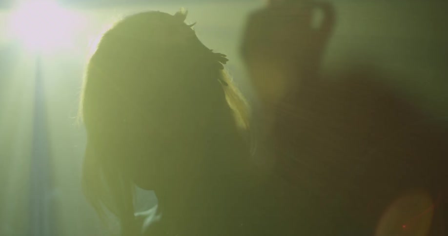 A person standing in front of strobe lights
