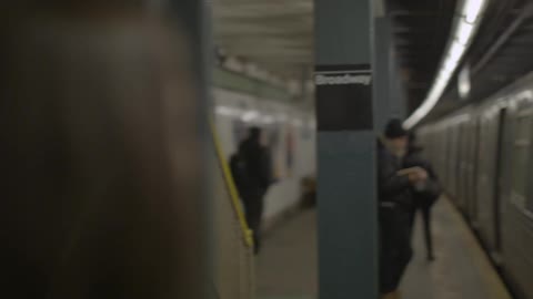 Woman waits and gets on the train in the subway station