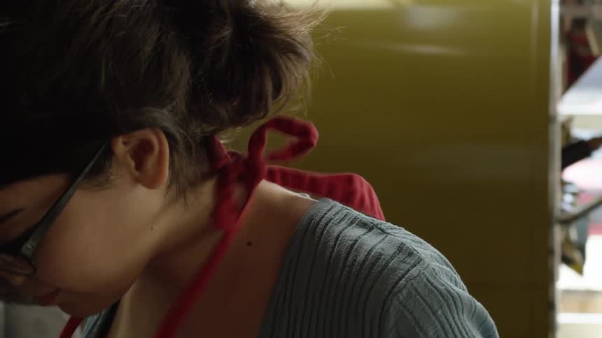 A woman is preparing to cook