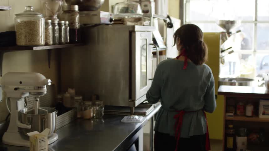 Woman putting butter to melt in an oven