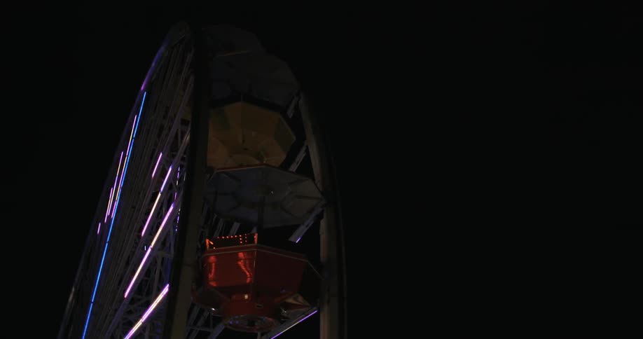 A ferris wheel lights up against the night sky