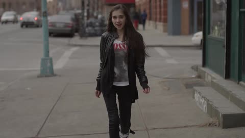 A woman is walking down the street