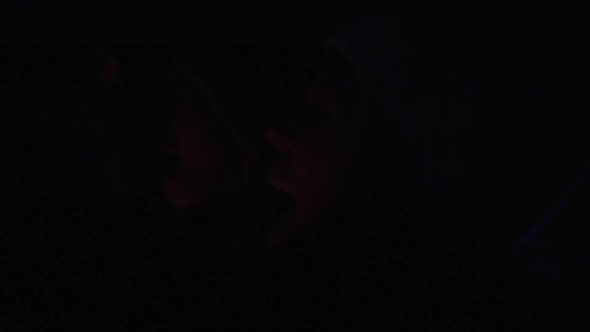 Women celebrating outside in the dark with fireworks going off in the background