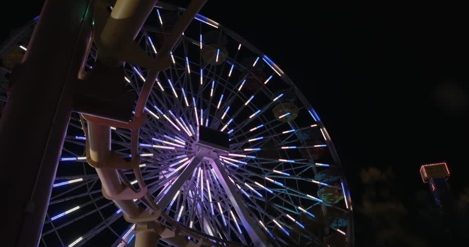 A ferris wheel is illuminated