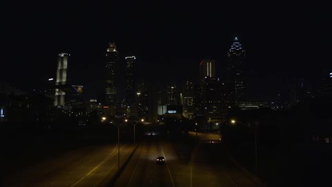 A car drives along a highway at night