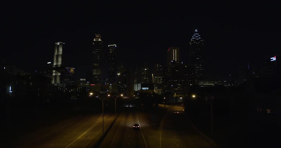 A car drives along a highway at night
