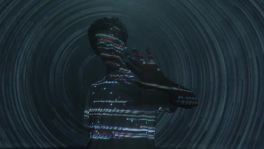 Young man with lights running over him in the dark