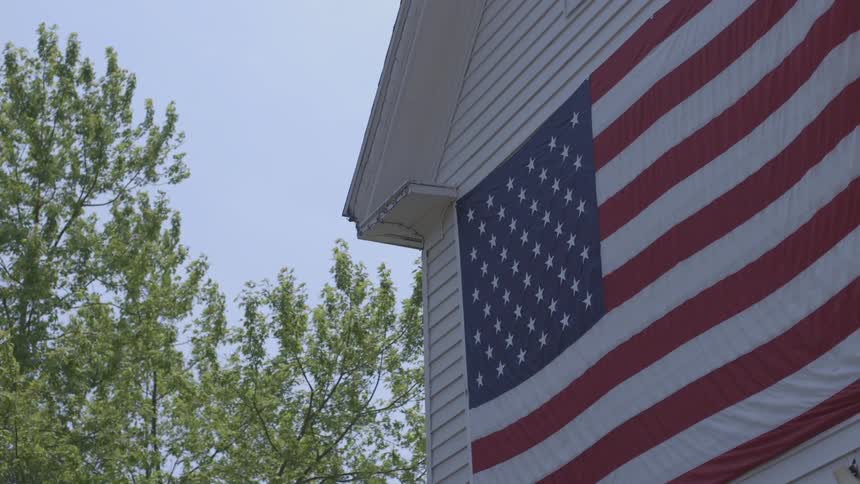 A flag stands outside a building