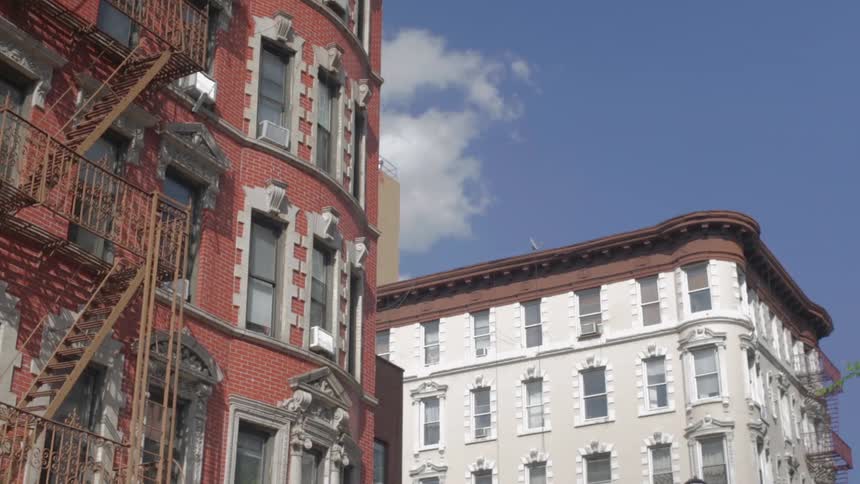 Buildings are shown on a sunny day