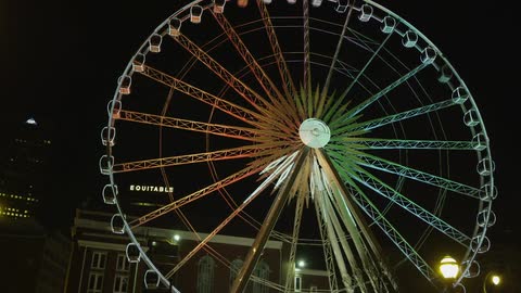 A ferris wheel lights up against the night sky