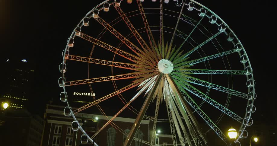 A ferris wheel lights up against the night sky