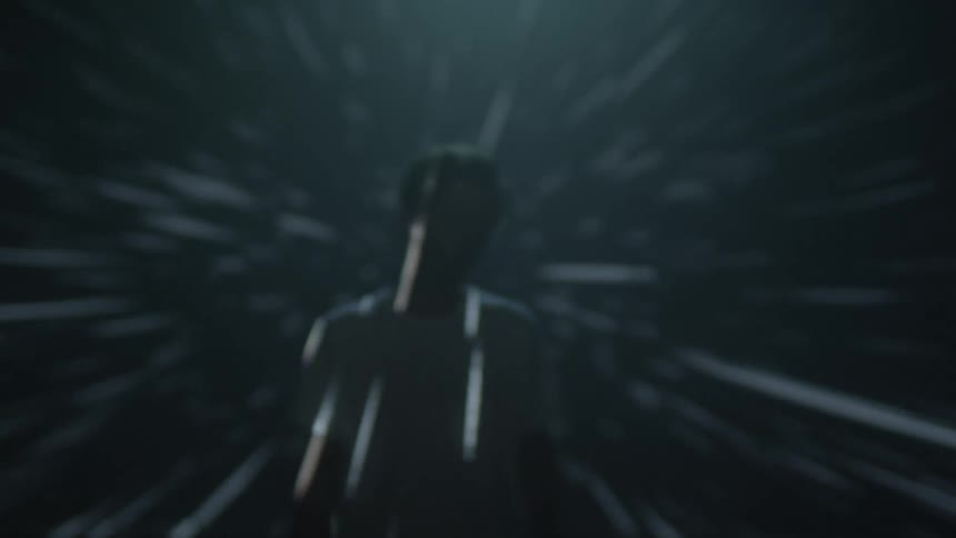A man stands while light passes over him