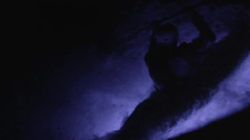 A person white water rafting at night